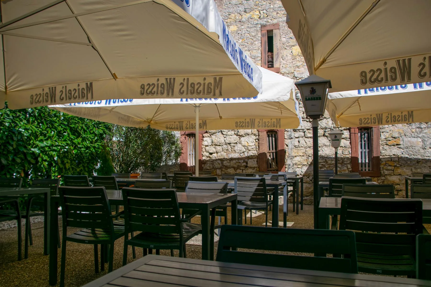 Gartenwirtschaft des Salento mit Tischen unter Sonnenschirmen